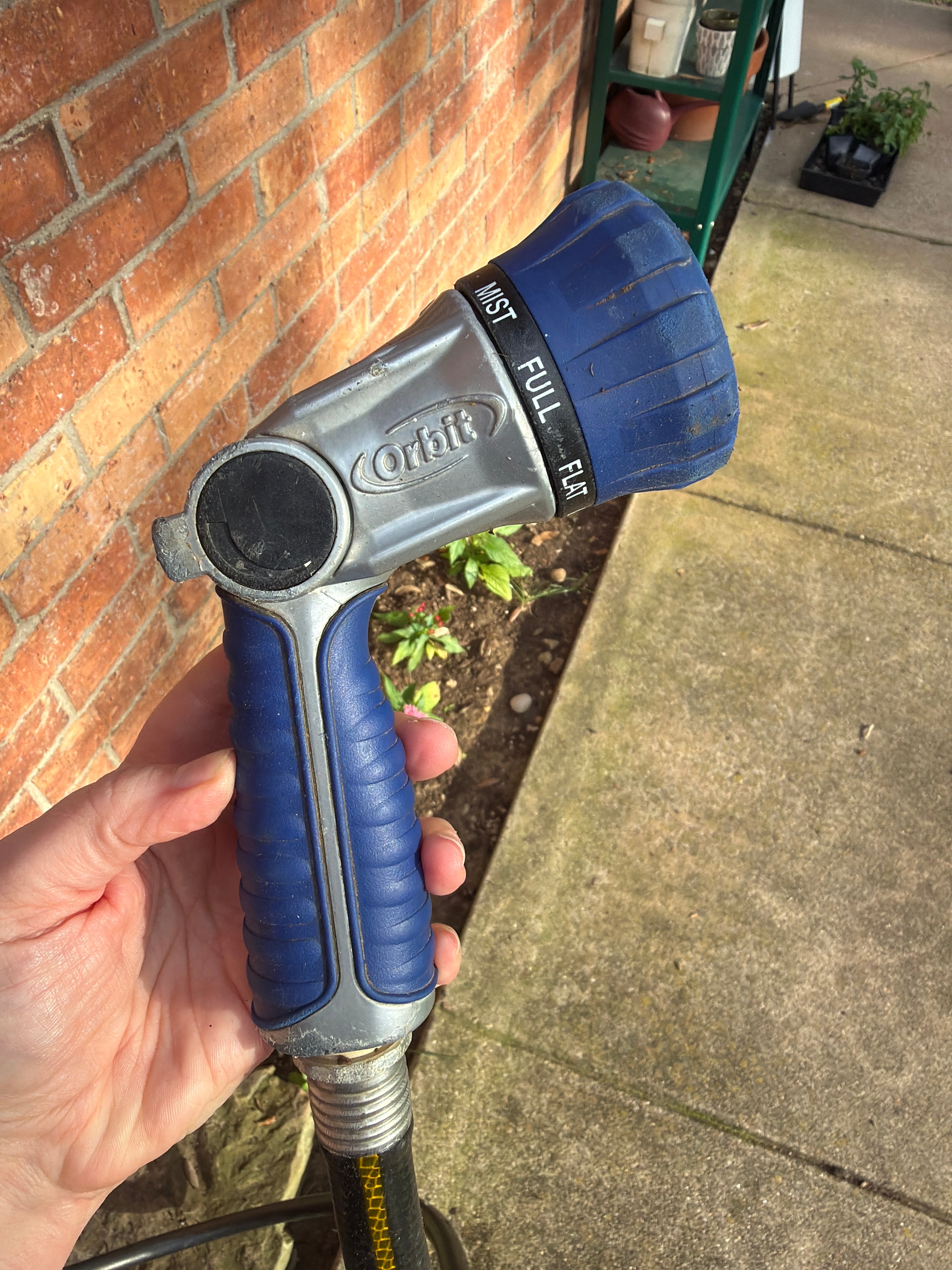 Garden hose with spray nozzle