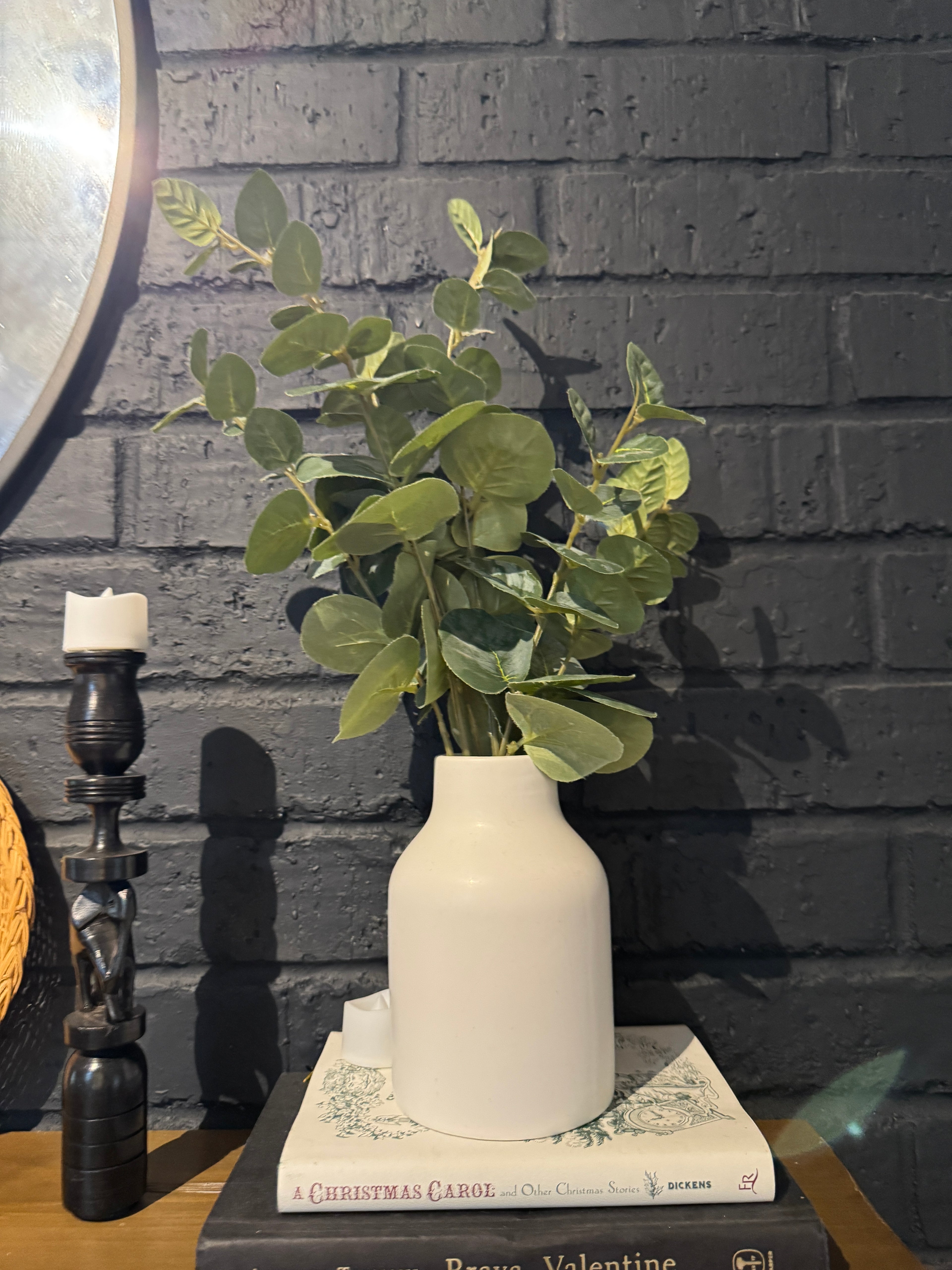 Faux plant in white vase