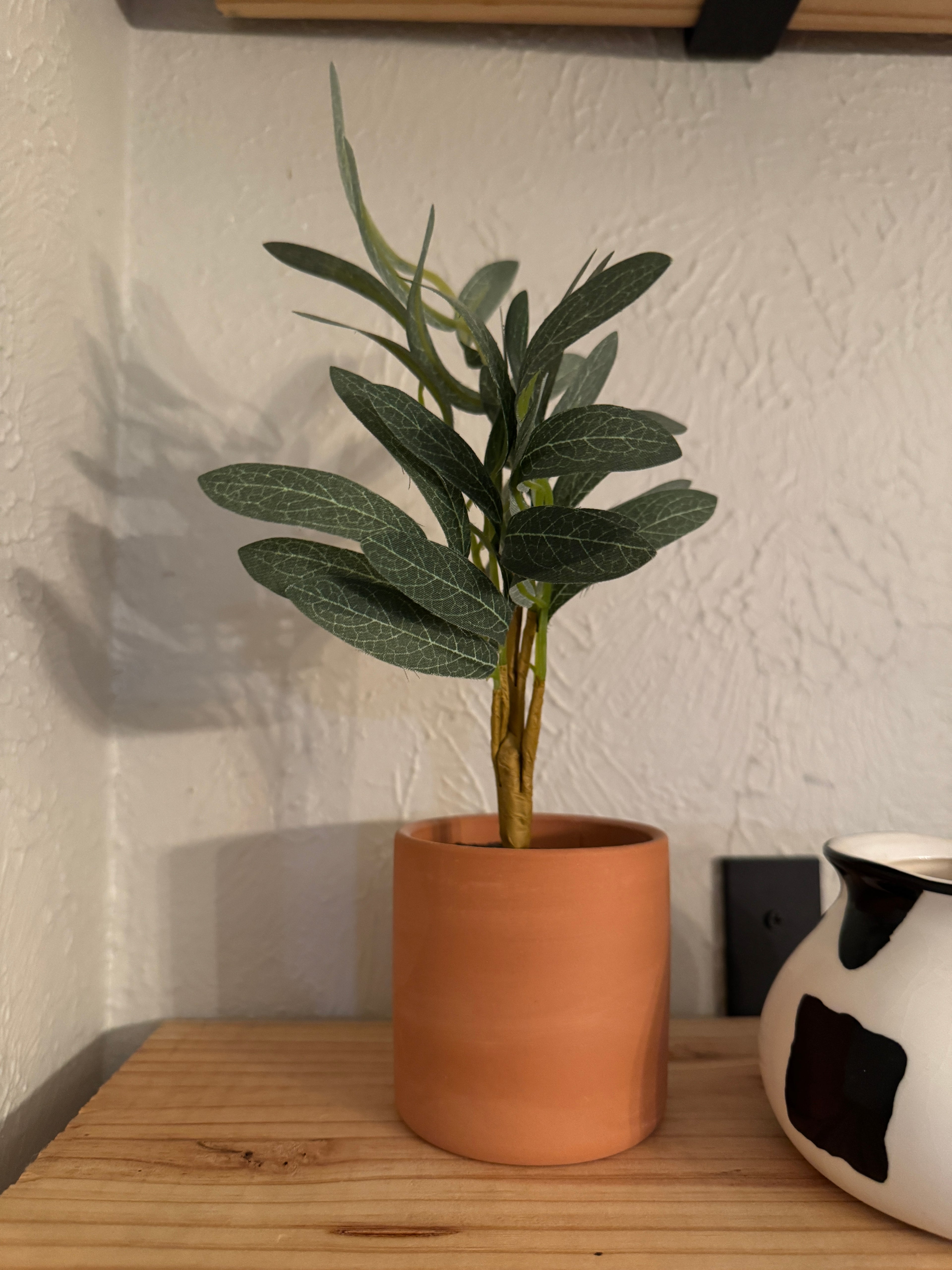 Small faux plant in clay pot