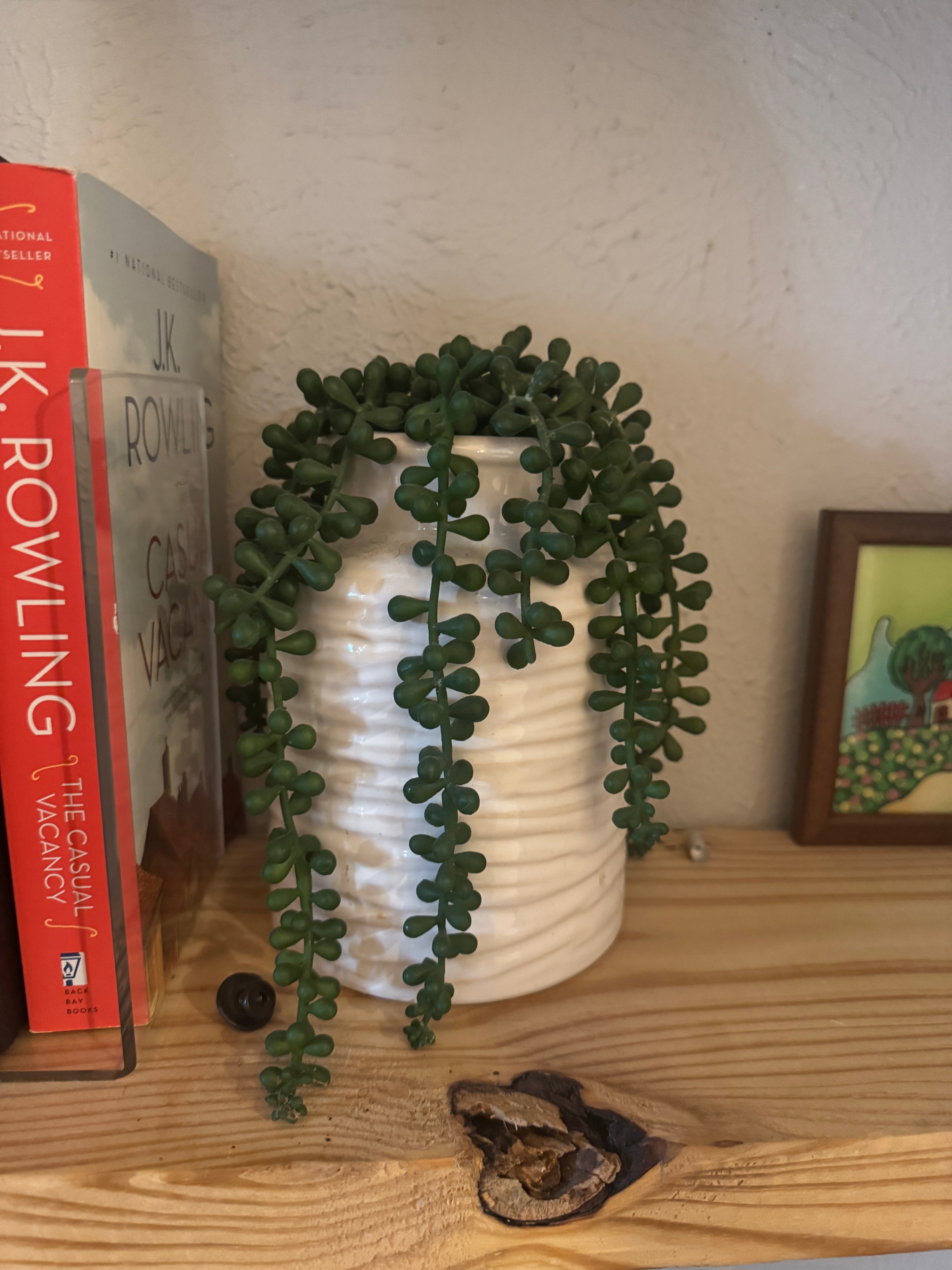 Fake plant in a white vase