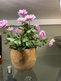 Faux pink flowers in wood planter