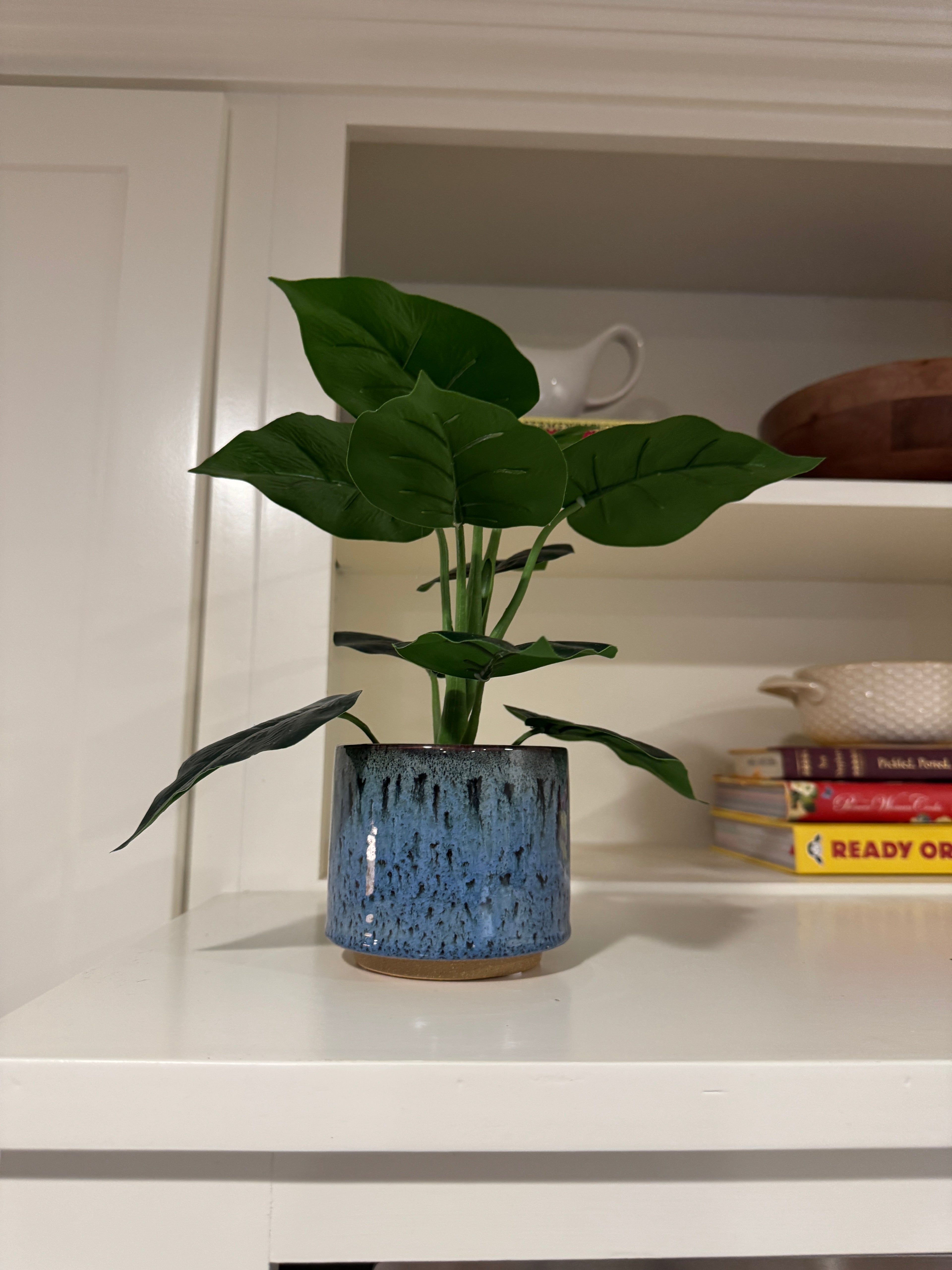 Faux plant in a blue pot